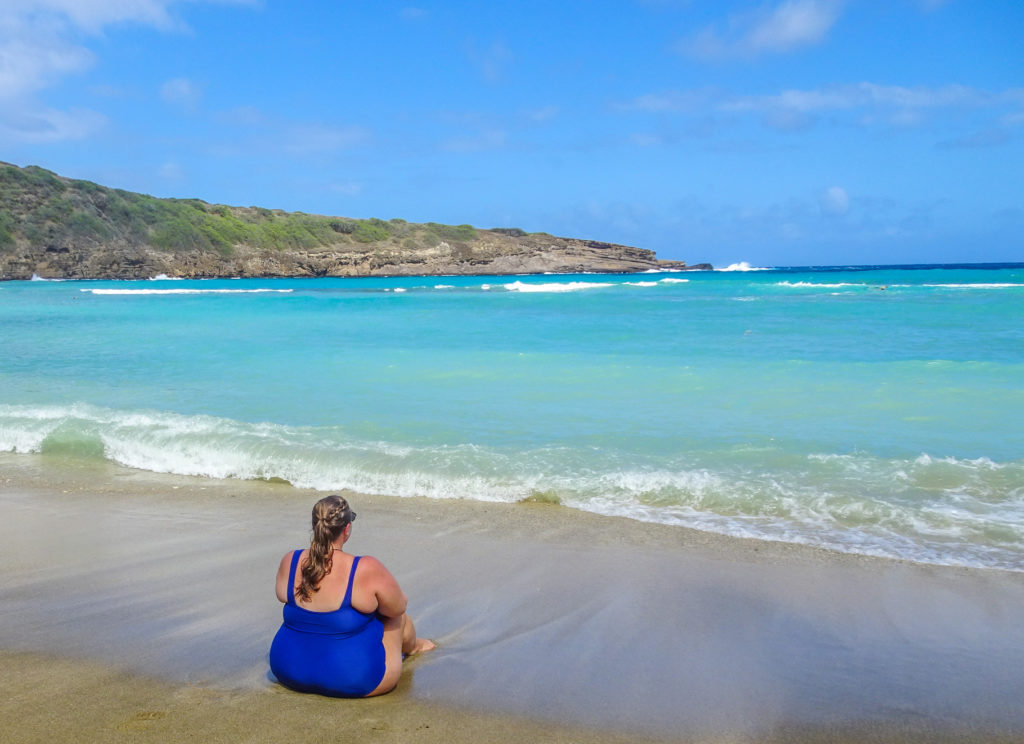 Girl sitting on the beach in Oahu, Hawaii