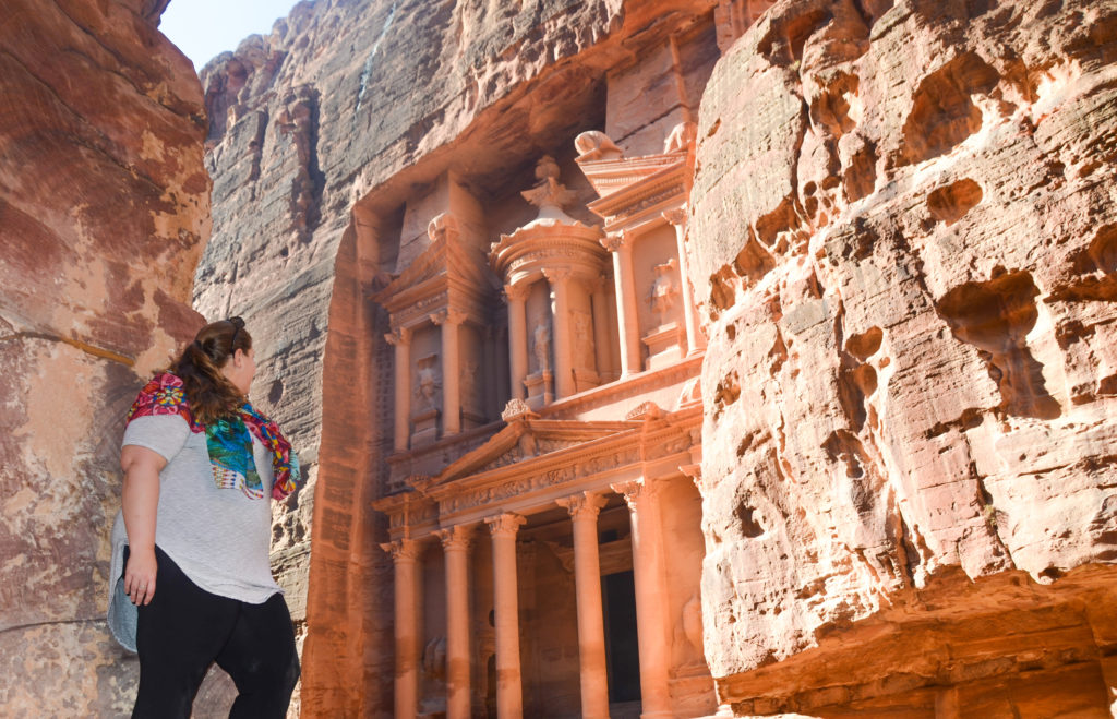 Standing on a rock looking to the Treasury of Petra in Jordan