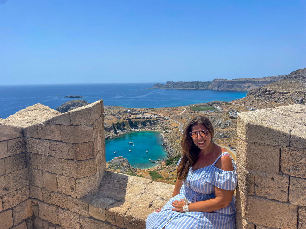Hannah sitting on the walls of the acropolis in Lindos, Rhodes