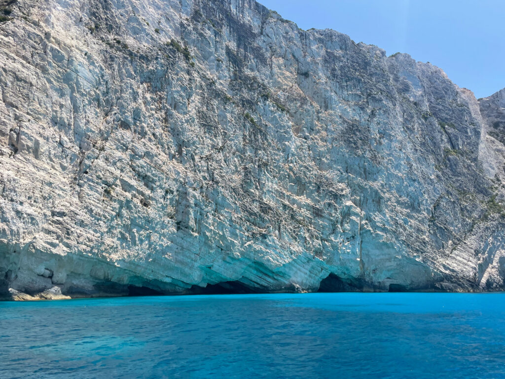 bright blue water and white cliffs with caves