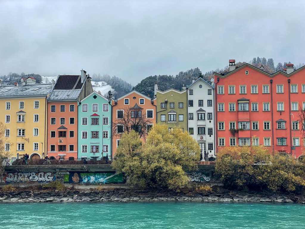 brightly coloured home on the riverbank in Innsbruck