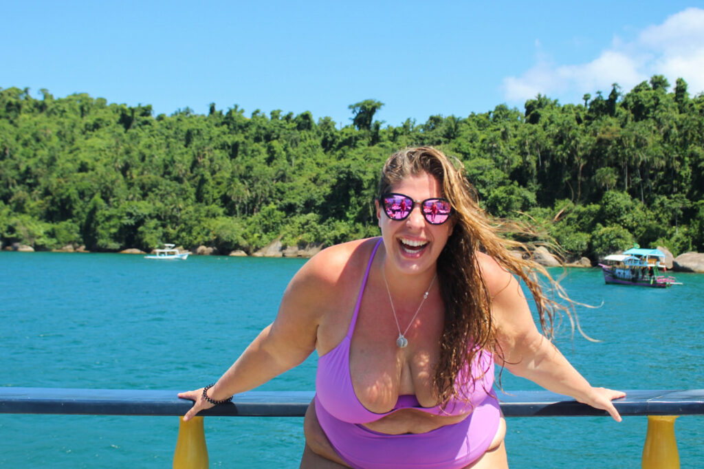 Hannah laughing in a purple bikini on a boat