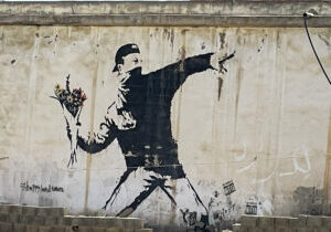 Banksy Art of Man throwing flowers in Bethlehem